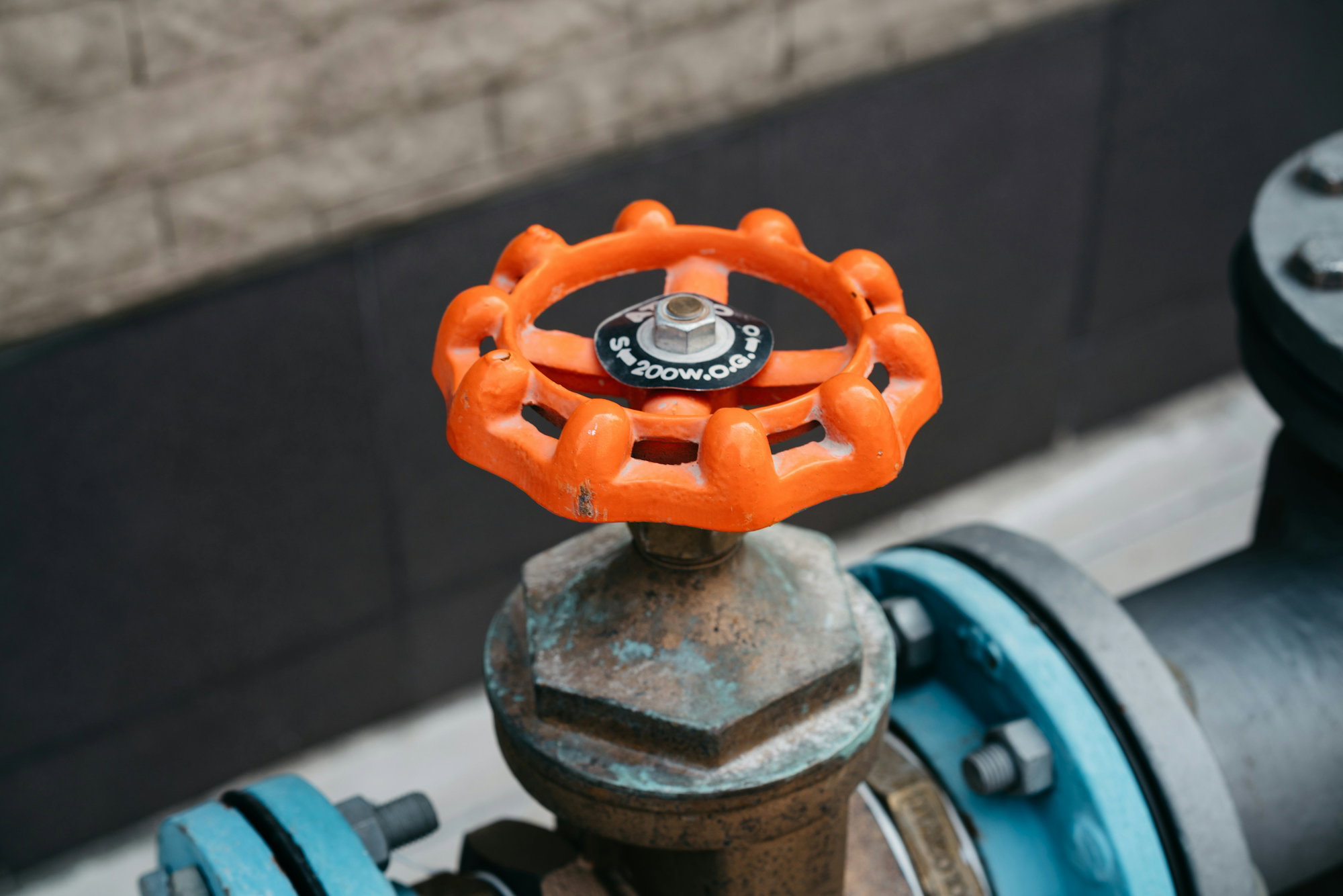 a-close-up-of-an-orange-and-black-fire-hydrant.jpg a close up of an orange and black fire hydrant